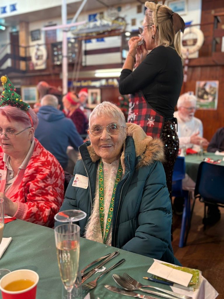 Two guests smiling at the Christmas dinner