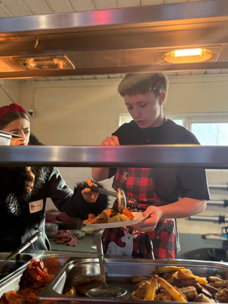 Young volunteer plating a Christmas meal