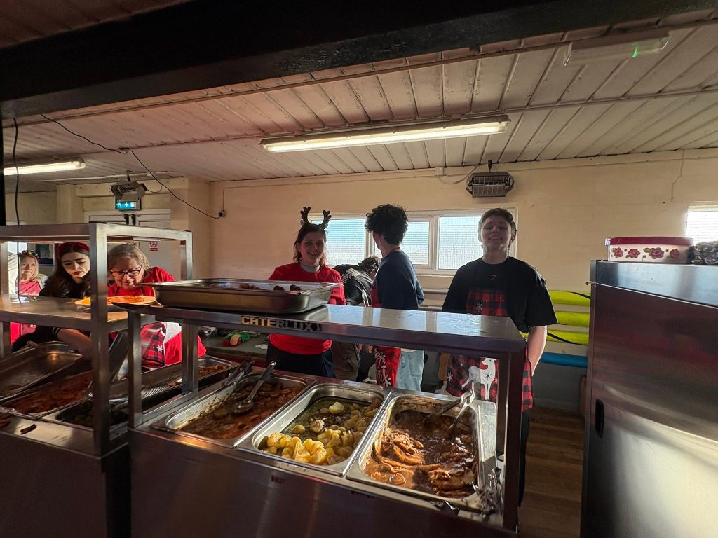 Volunteers serving Christmas food at the counter
